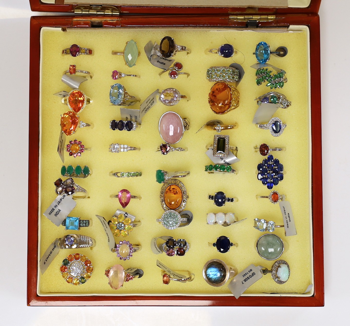 Forty seven assorted modern 925 and gem set rings and seven assorted modern 9ct gold and gem set rings, in ring box (hinges damaged).